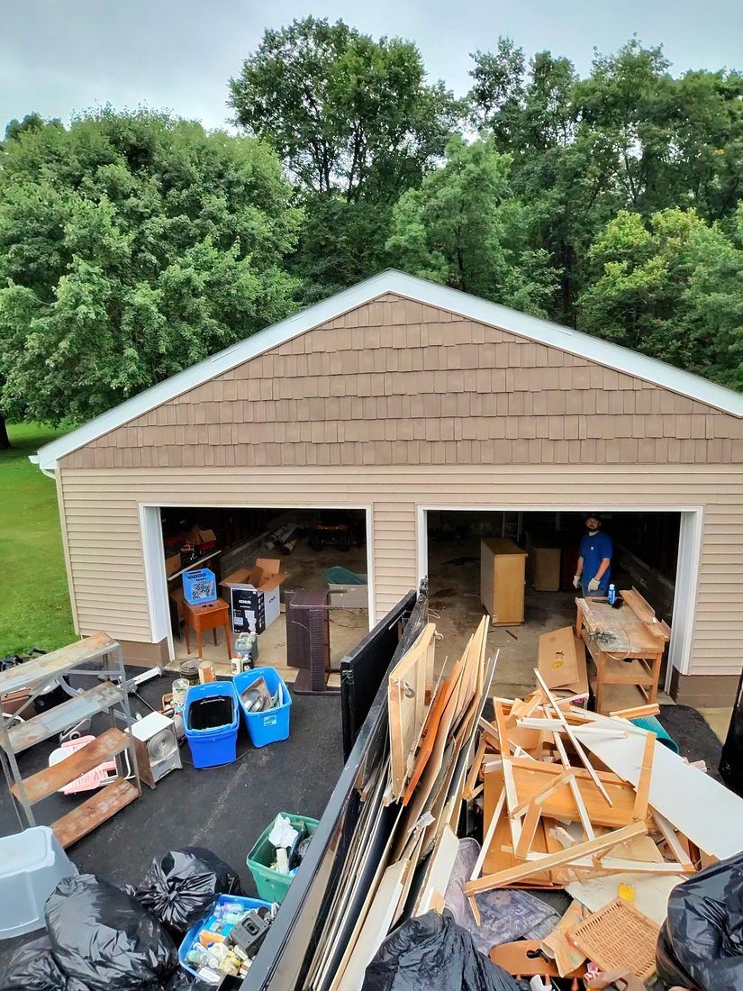 A two-car garage cleared out onto the driveway during an Iron Valor job.